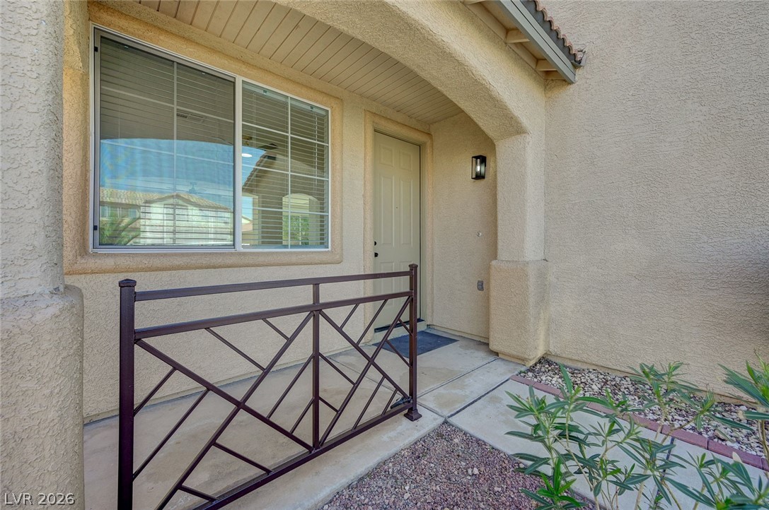 9687 Ridgebluff Avenue Las Vegas, NV 89148 - Photo 5 of 57 View of exterior entry with stucco siding