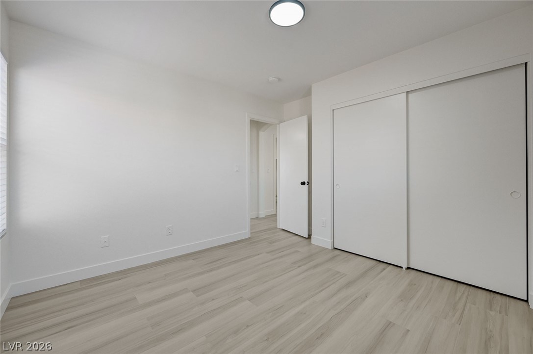 9687 Ridgebluff Avenue Las Vegas, NV 89148 - Photo 50 of 57 Unfurnished bedroom featuring light wood-style flooring and a closet