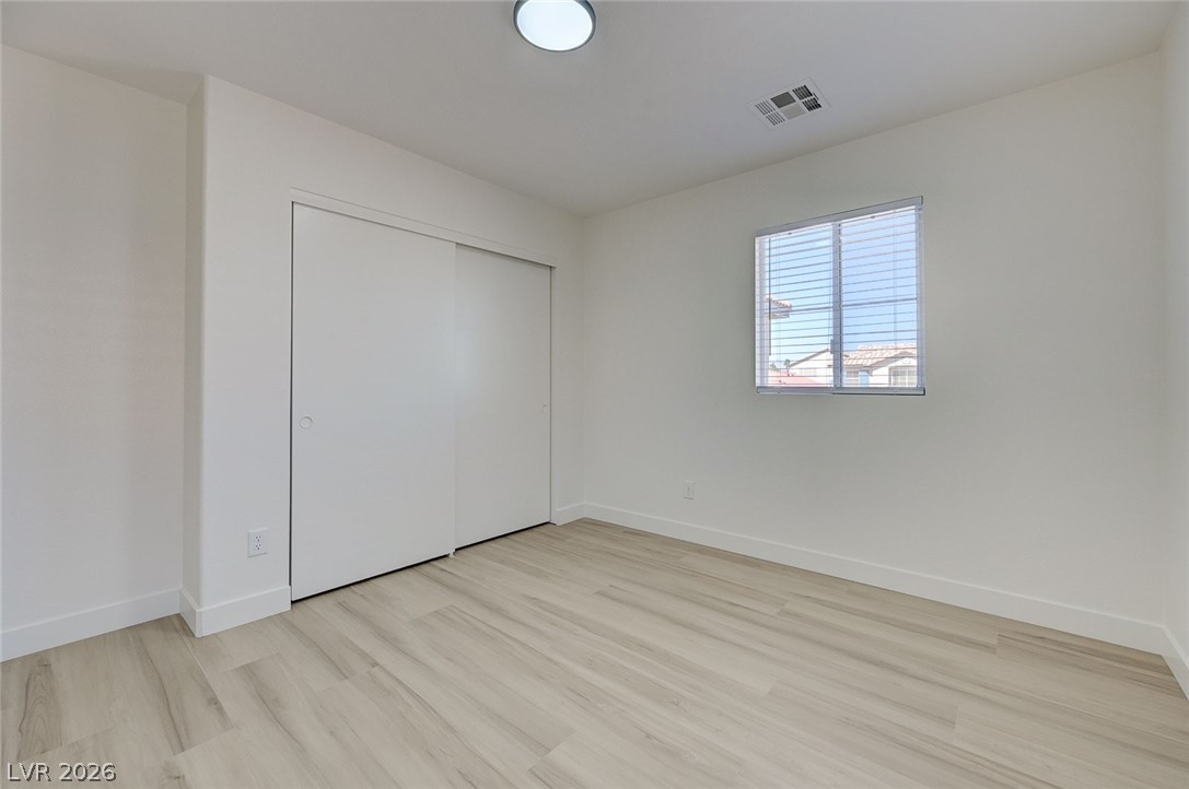 9687 Ridgebluff Avenue Las Vegas, NV 89148 - Photo 51 of 57 Unfurnished bedroom featuring light wood finished floors and a closet