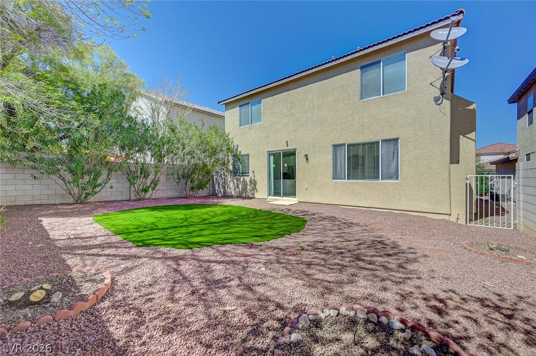 9687 Ridgebluff Avenue Las Vegas, NV 89148 - Photo 55 of 57 Back of property featuring a fenced backyard, stucco siding, and a patio area
