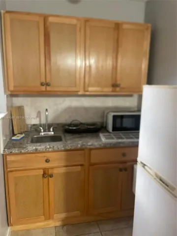 a kitchen with cabinets and stainless steel appliances