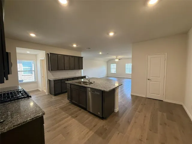 a kitchen with stainless steel appliances granite countertop a stove and a sink
