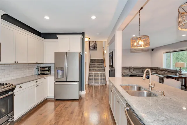 a kitchen with a sink refrigerator and cabinets