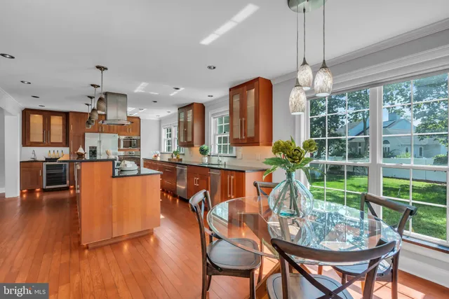 a dining room with furniture a chandelier and wooden floor