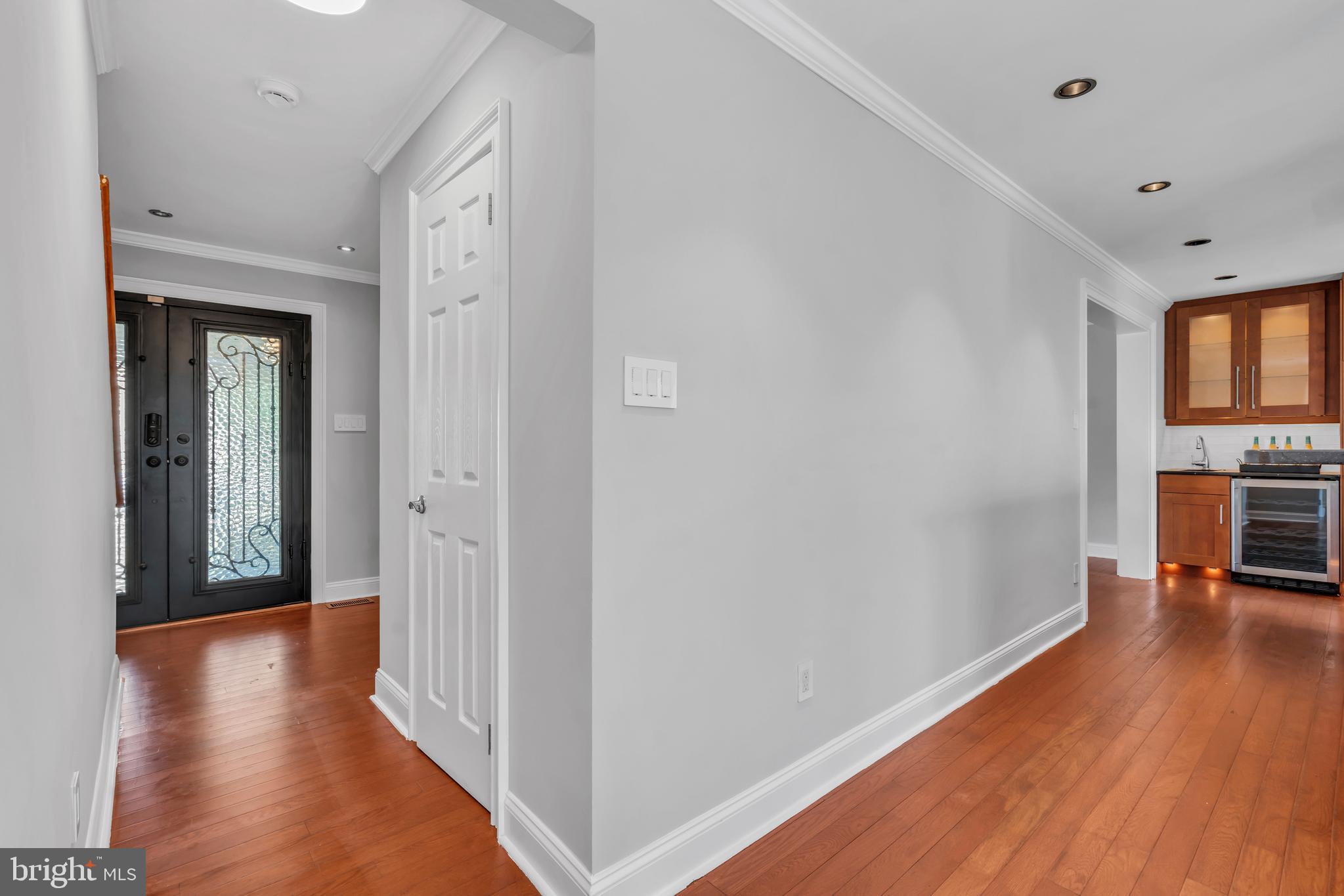 1 Crisfield Road Sicklerville, NJ 08081 - Photo 23 of 45 a view of a hallway with wooden floor and a kitchen