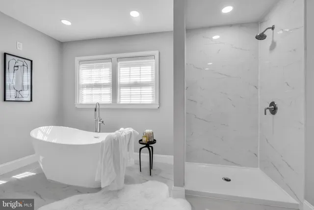 a bath tub sitting next to a white sink