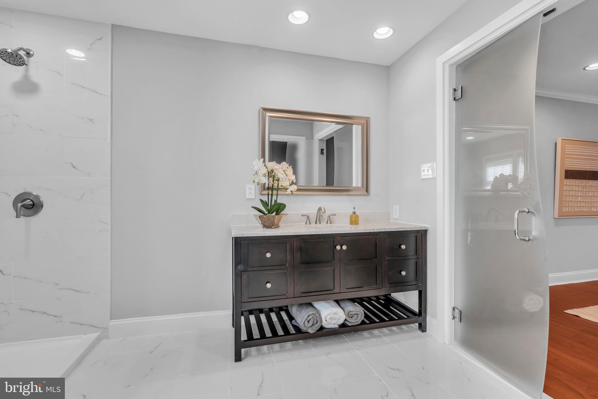 1 Crisfield Road Sicklerville, NJ 08081 - Photo 30 of 45 a bathroom with a double vanity sink a mirror and a bathtub