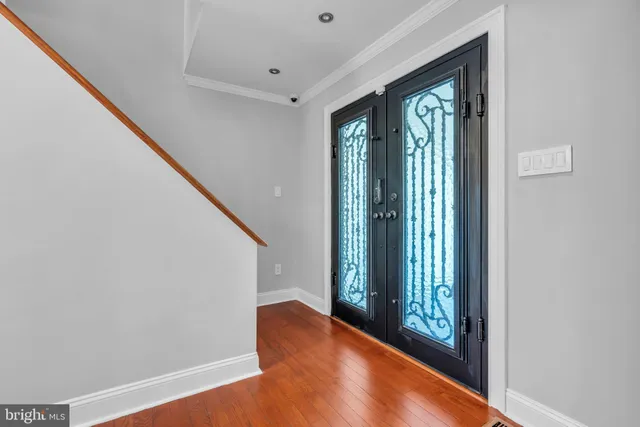 a view of an entryway with wooden floor