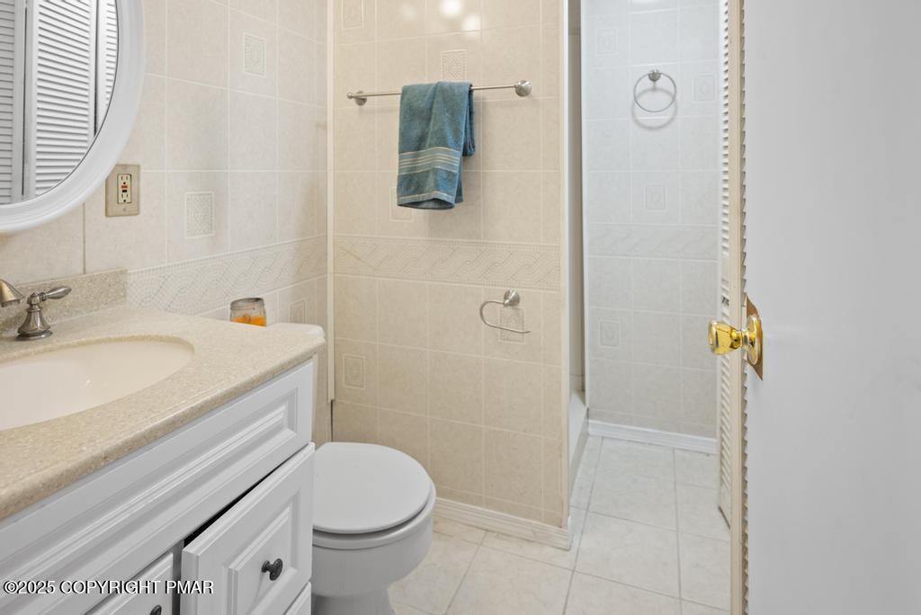 136 Netcong Circle Pocono Lake, PA 18347 - Photo 23 of 40 a bathroom with a granite countertop sink toilet and shower
