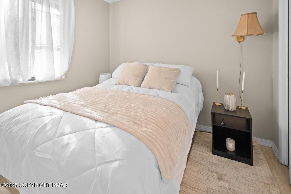 136 Netcong Circle Pocono Lake, PA 18347 - Photo 37 of 40 a spacious bedroom with a bed and window