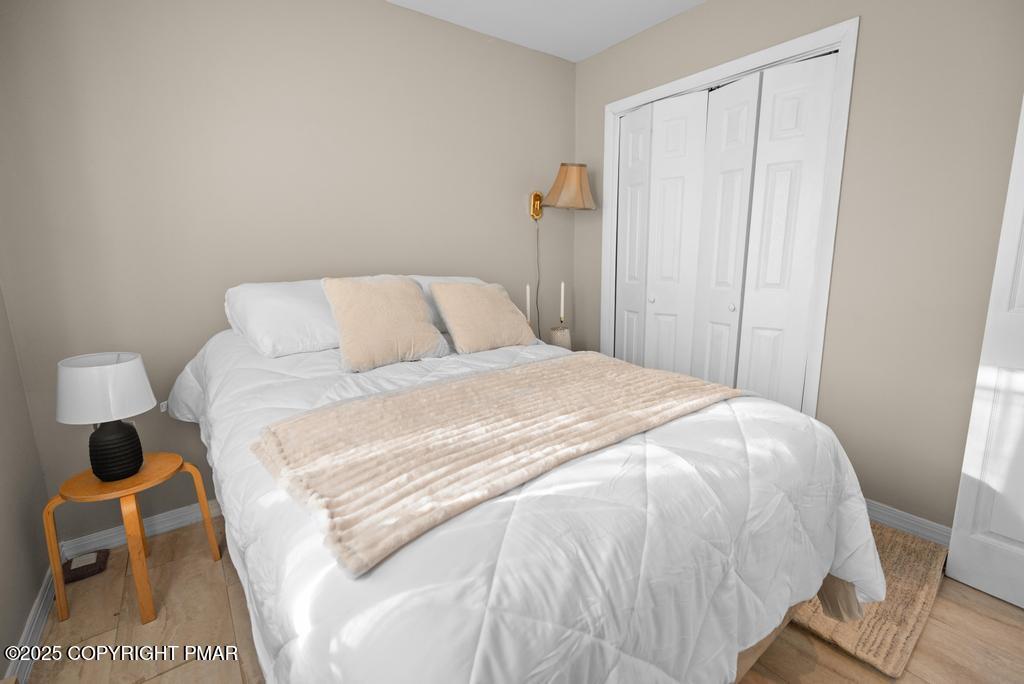 136 Netcong Circle Pocono Lake, PA 18347 - Photo 38 of 40 a large bed sitting in a bedroom next to a window