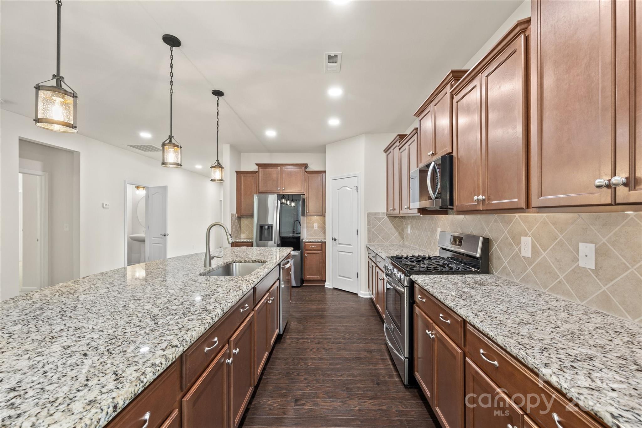 2337 Talon Point Circle Fort Mill, SC 29715 - Photo 12 of 48 a kitchen with stainless steel appliances granite countertop a sink stove and refrigerator