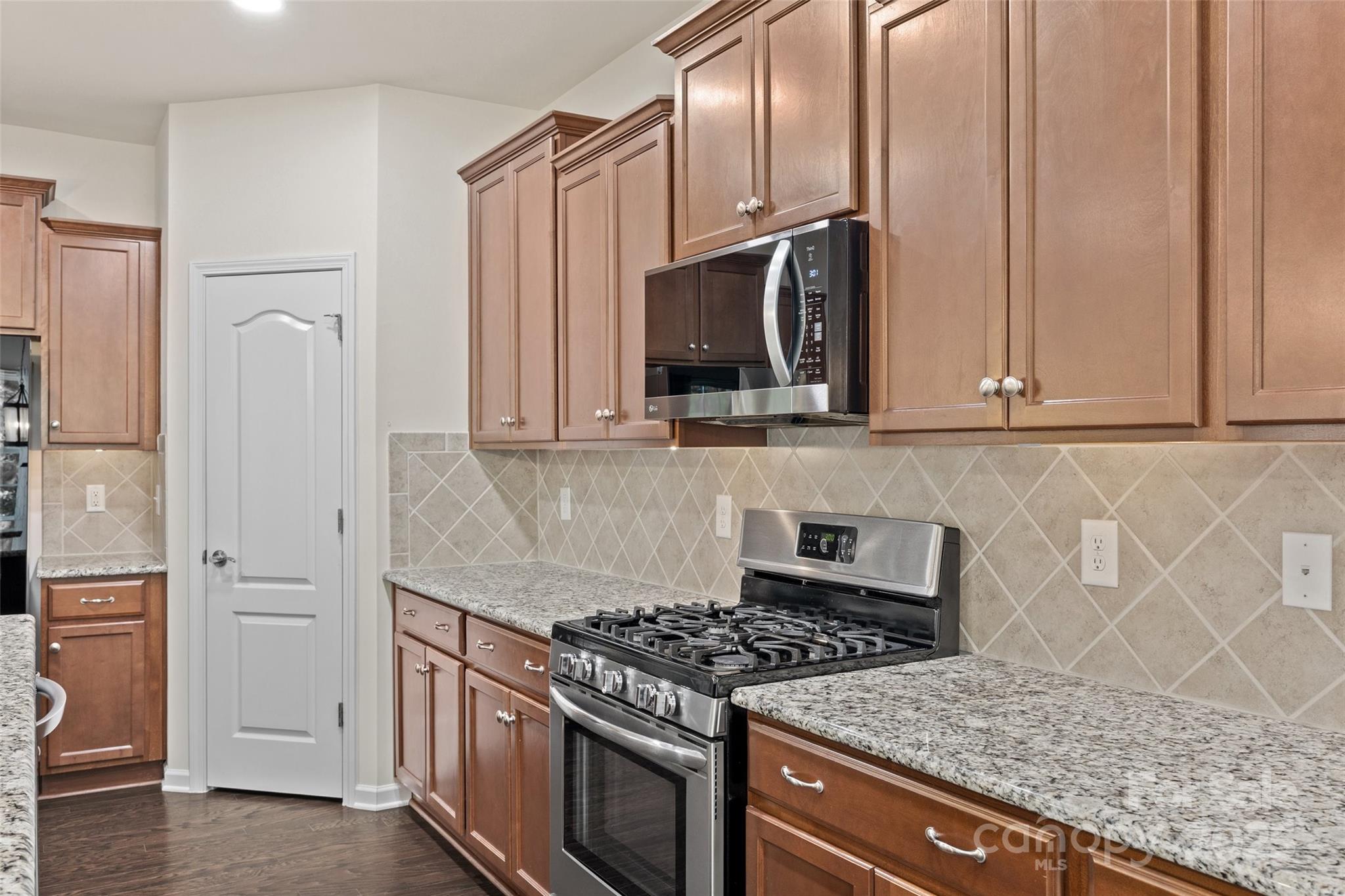 2337 Talon Point Circle Fort Mill, SC 29715 - Photo 13 of 48 a kitchen with stainless steel appliances granite countertop a stove and a microwave