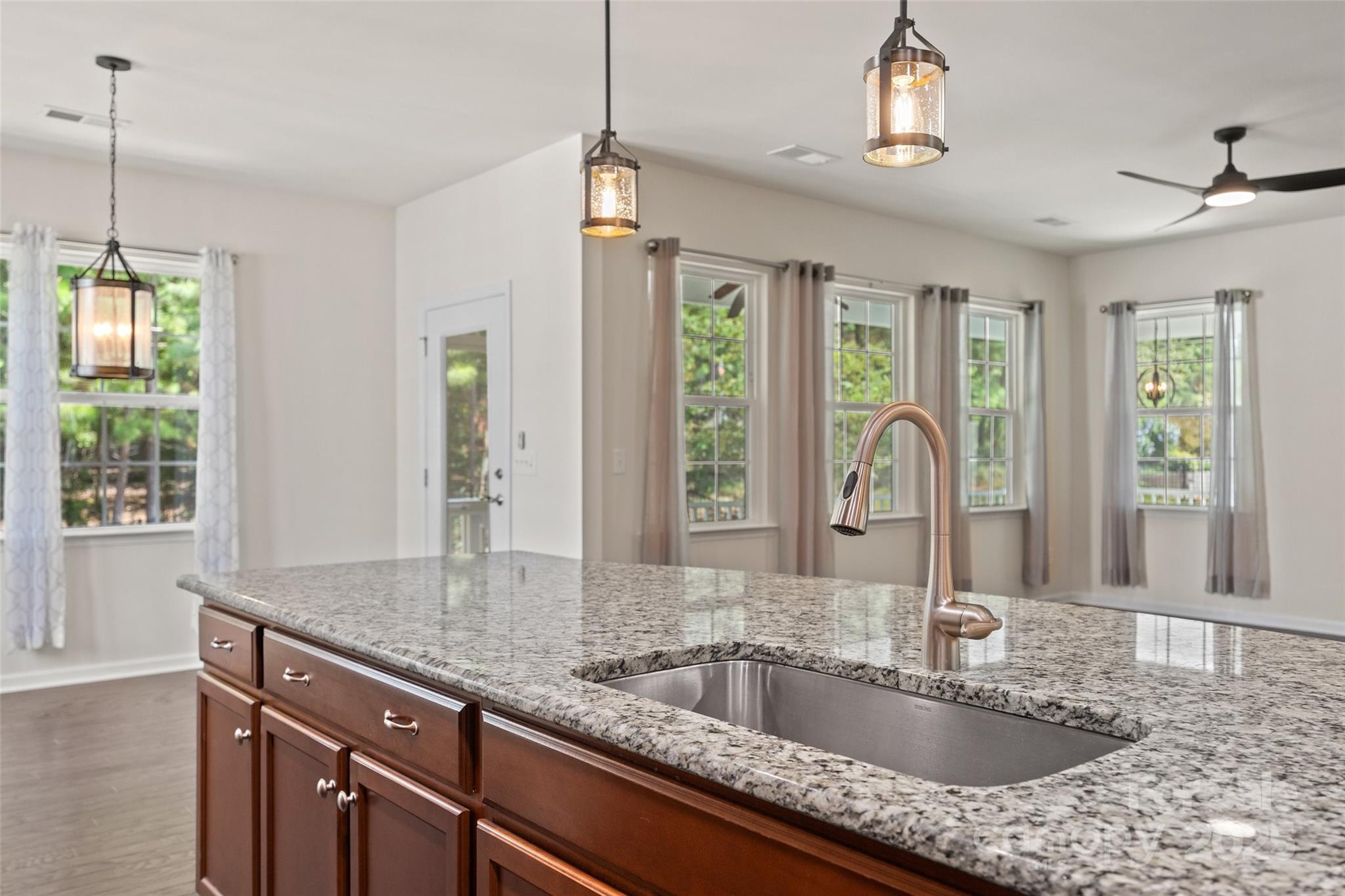 2337 Talon Point Circle Fort Mill, SC 29715 - Photo 15 of 48 a kitchen with granite countertop a sink and dishwasher with wooden floor