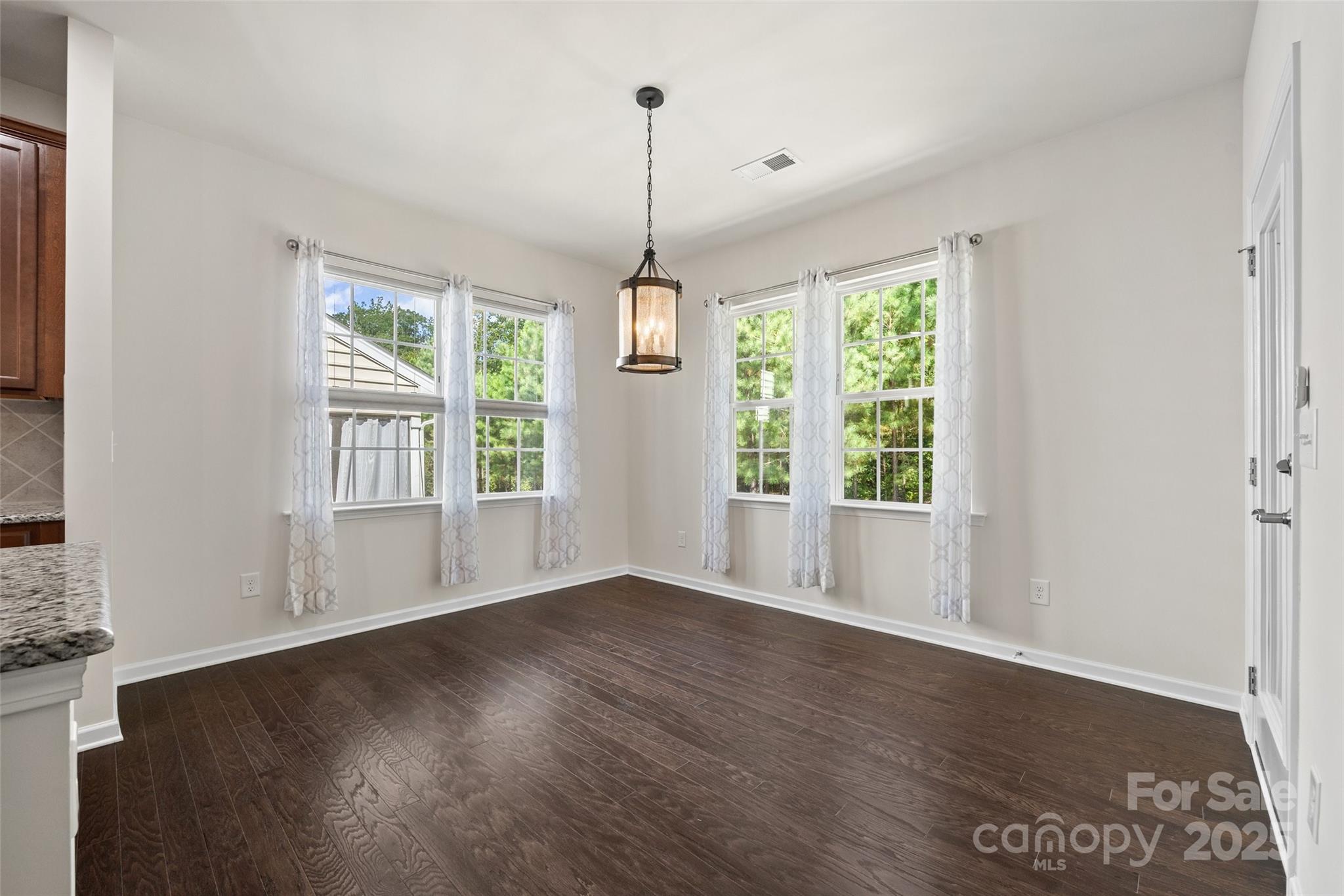 2337 Talon Point Circle Fort Mill, SC 29715 - Photo 16 of 48 a view of an empty room with wooden floor and a window