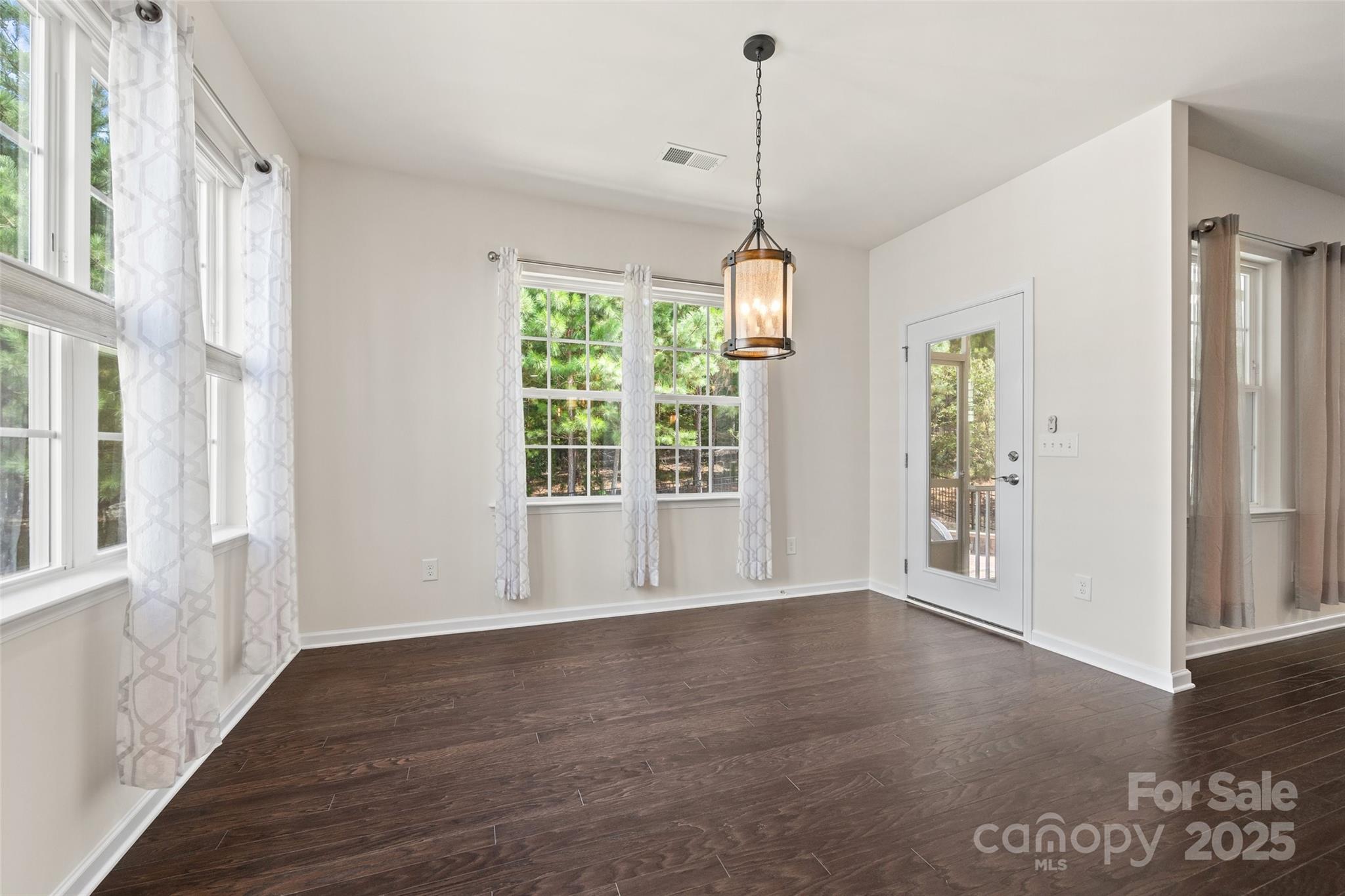 2337 Talon Point Circle Fort Mill, SC 29715 - Photo 17 of 48 a view of an empty room with wooden floor and a window