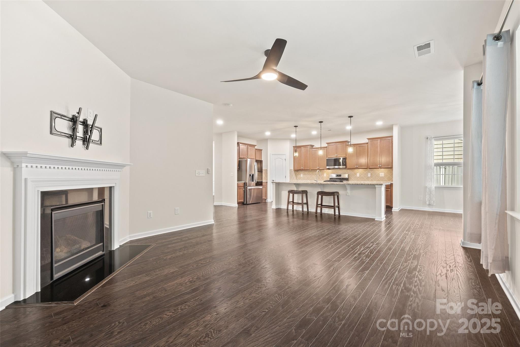 2337 Talon Point Circle Fort Mill, SC 29715 - Photo 20 of 48 a view of a room with wooden floor and a kitchen
