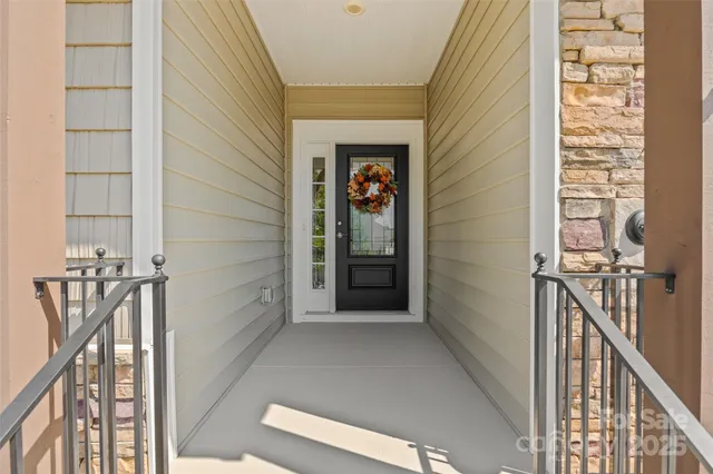 a view of a hallway with wooden floor and entryway