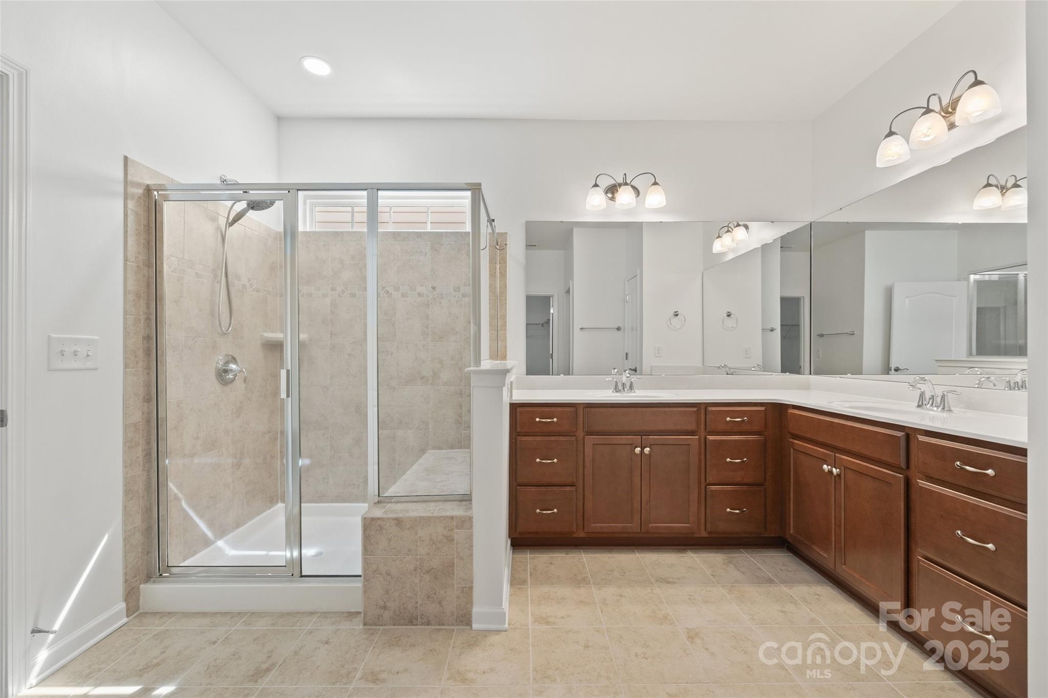 2337 Talon Point Circle Fort Mill, SC 29715 - Photo 25 of 48 a spacious bathroom with a mirror a sink and a shower