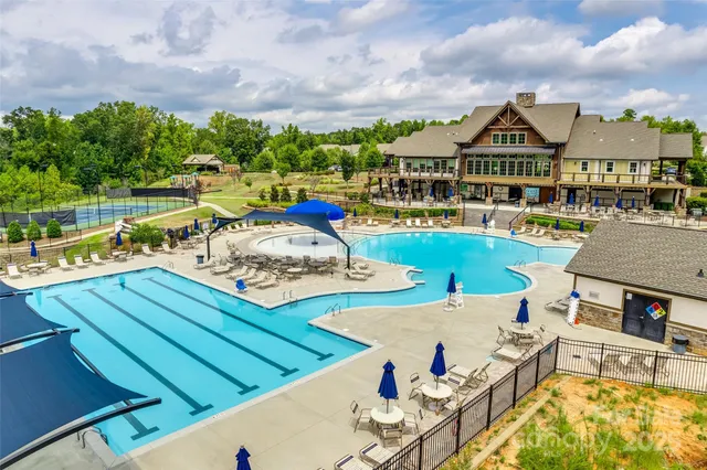 a view of a swimming pool with a yard