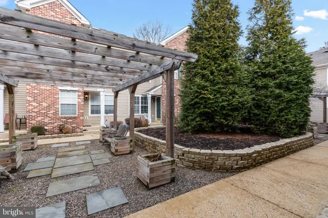 a view of a patio with table and chairs and potted plants