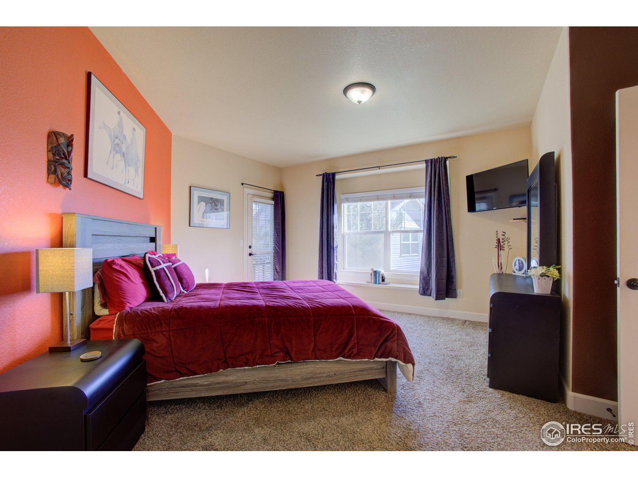 1515 Waterfront Drive Windsor, CO 80550 - Photo 19 of 40 The primary suite is located a the rear of the house. You can access the back covered deck from the door to the left in this picture