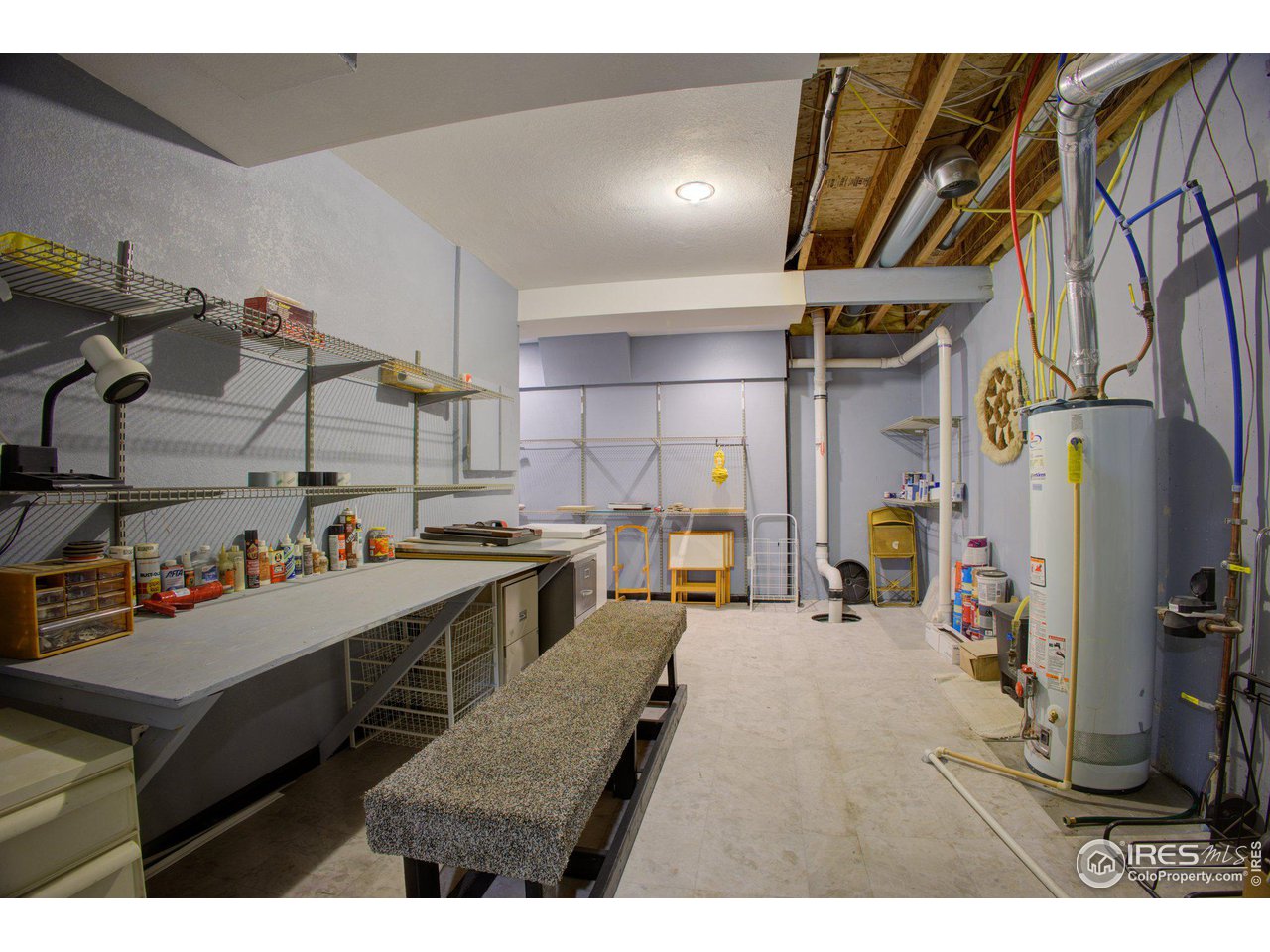 1515 Waterfront Drive Windsor, CO 80550 - Photo 31 of 40 The unfinished mechanical room allows enough space for a workshop and storage. There's plenty of shelving as well