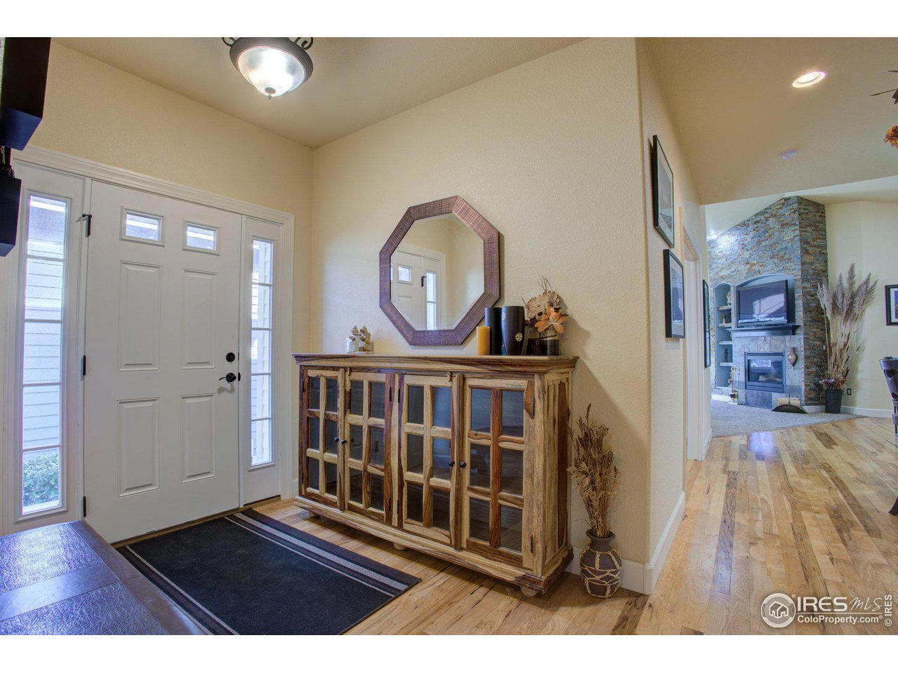 1515 Waterfront Drive Windsor, CO 80550 - Photo 7 of 40 The side entry is in the middle of the house. Guests to the left, owners to the right. The gathering spaces are in the middle and in the basement below