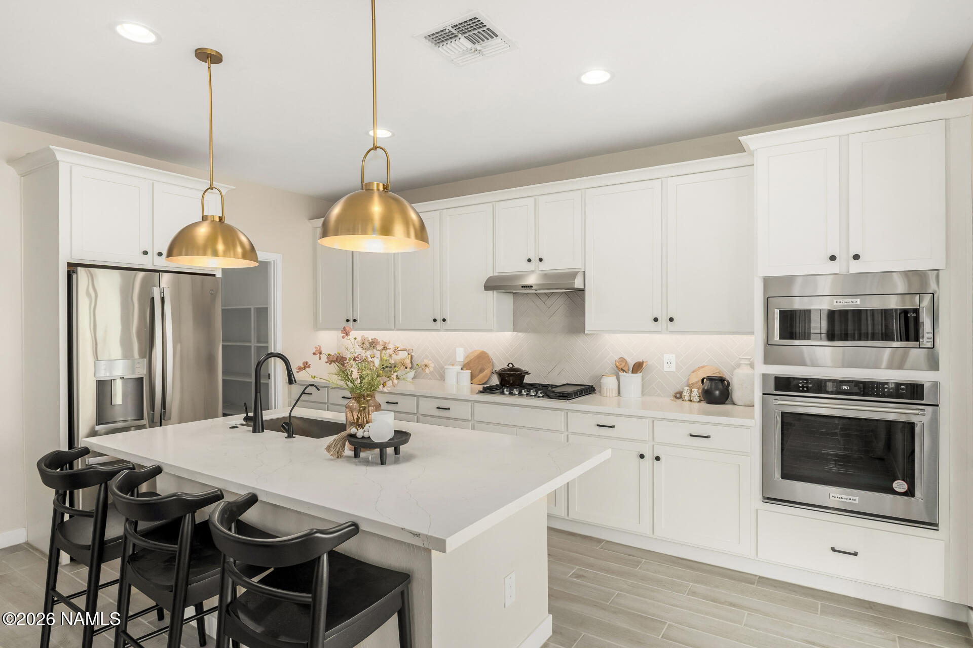 6413 North 17th Street Phoenix, AZ 85016 - Photo 22 of 26 a kitchen with stainless steel appliances a stove a sink a microwave a dining table and chairs