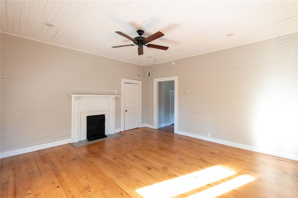 702 Radford Street Monroe, GA 30655 - Photo 26 of 49 a view of an empty room with a ceiling fan and a window