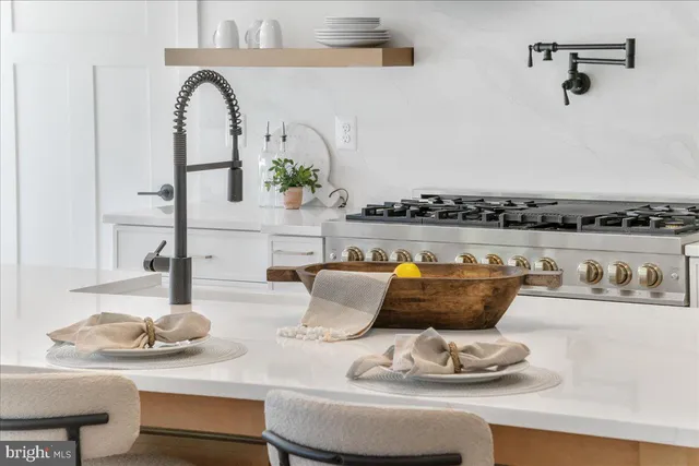 a kitchen with a stove a refrigerator and a sink