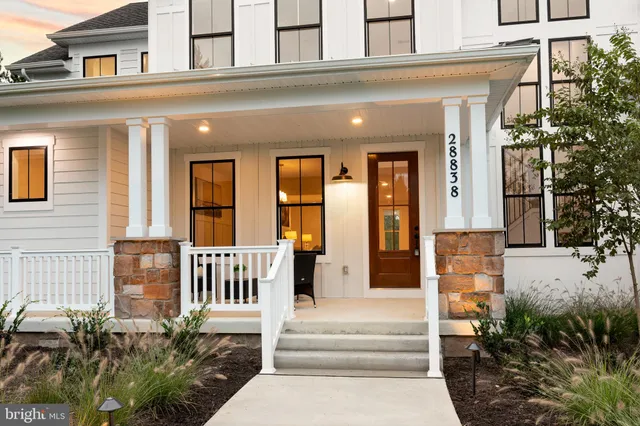 an aerial view of residential houses with outdoor space and lake view