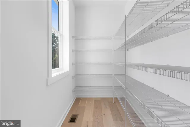 a view of staircase with white walls and windows