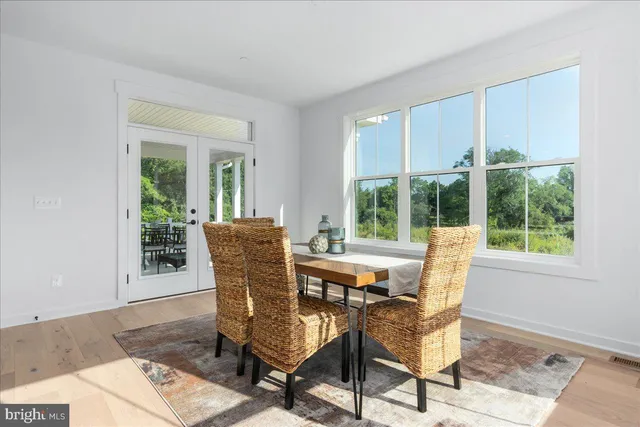 a view of a dining room with furniture and a window