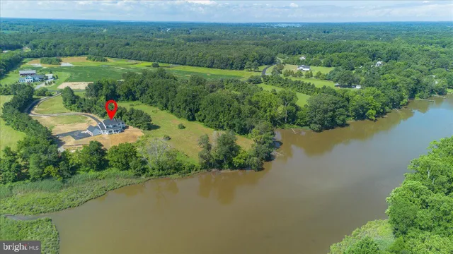 an aerial view of a house with a lake view