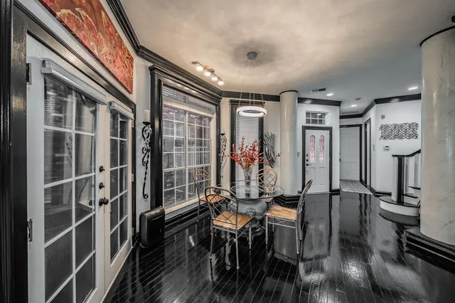 a view of a hallway with workspace and wooden floor