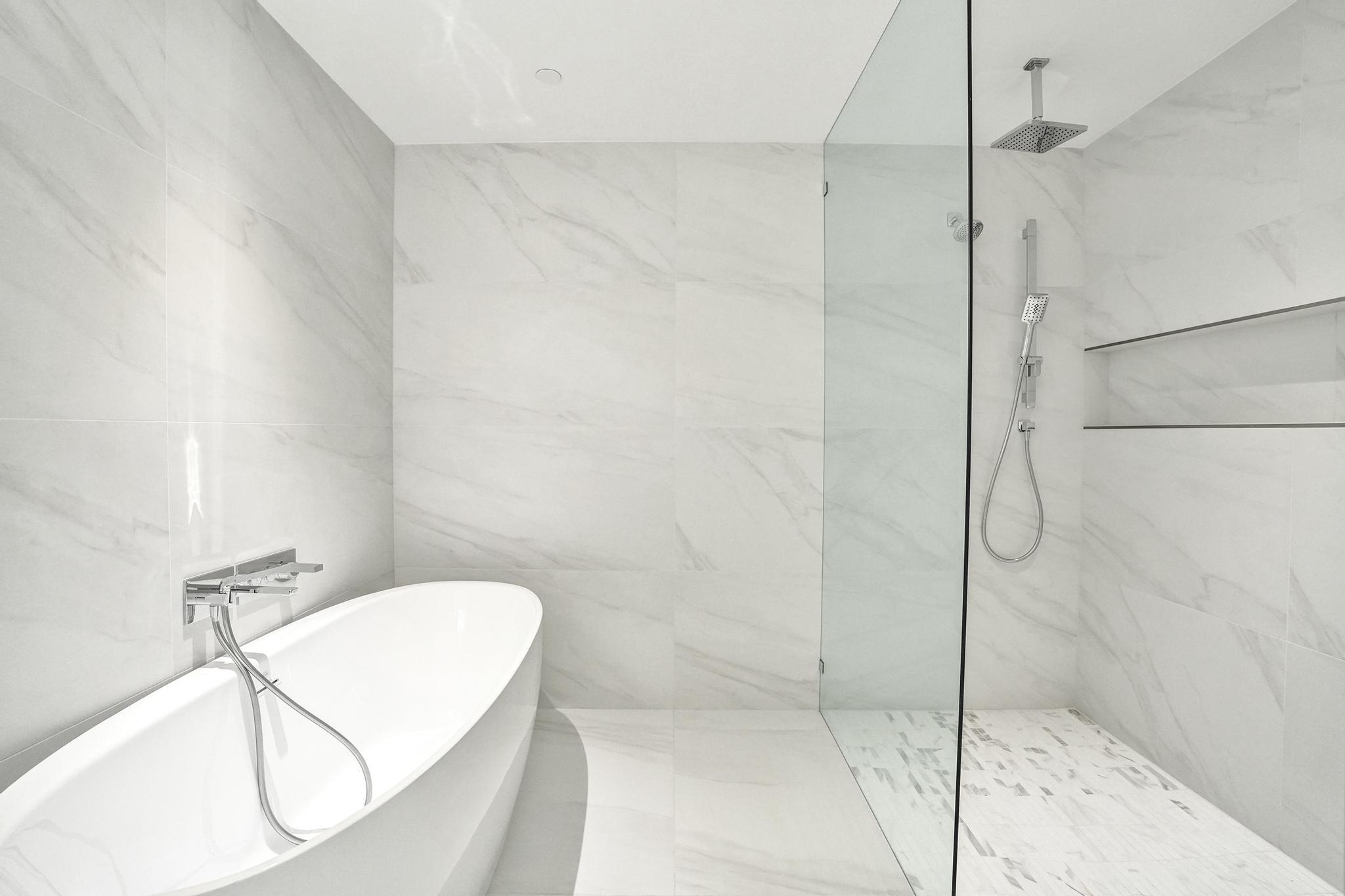 407 North Riverside Drive, Unit 303 Pompano Beach, FL 33062 - Photo 23 of 74 a bathroom with a bathtub and shower
