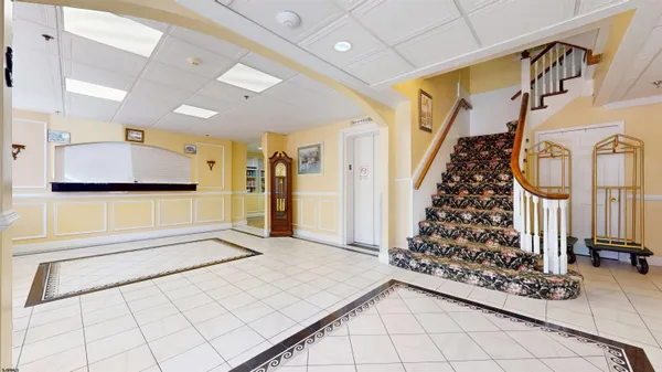 a view of a hallway with a door and stairs