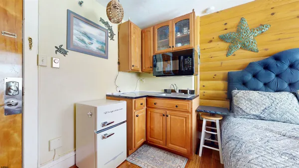 a kitchen with stainless steel appliances granite countertop a sink and a microwave