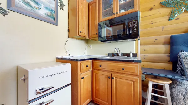 a kitchen with stainless steel appliances wooden cabinets and a sink