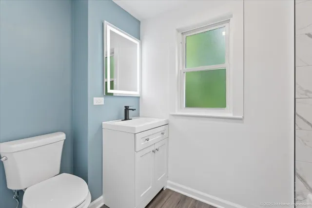 a bathroom with a toilet sink and window