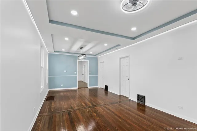 an empty room with wooden floor and window