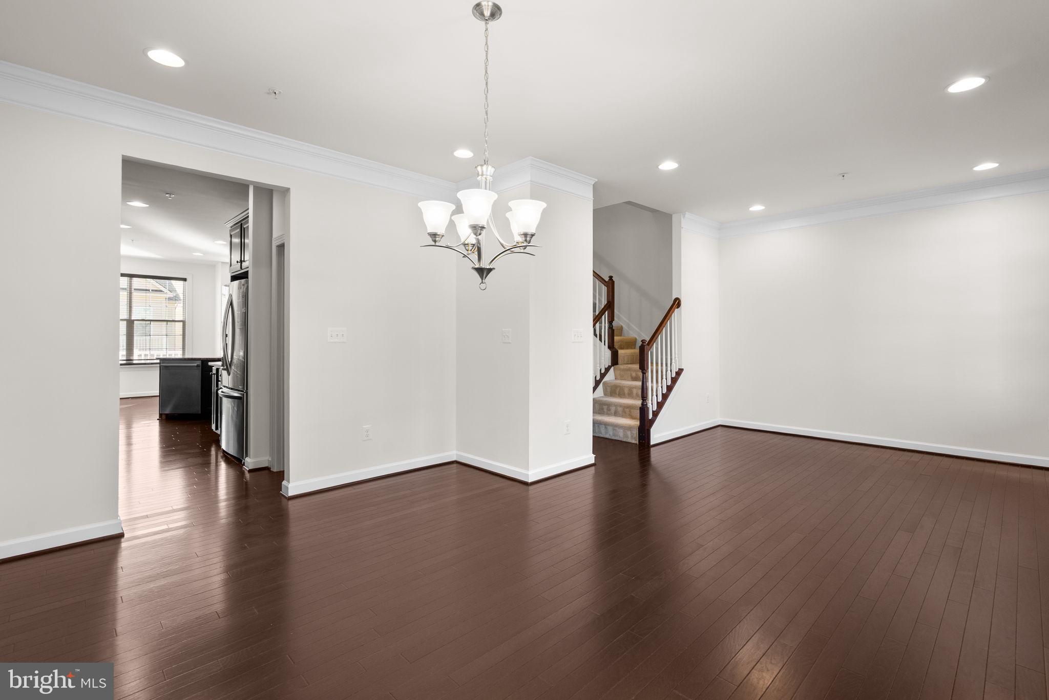 176 Autumn View Drive Gaithersburg, MD 20878 - Photo 11 of 45 a view of a livingroom with wooden floor and a chandelier