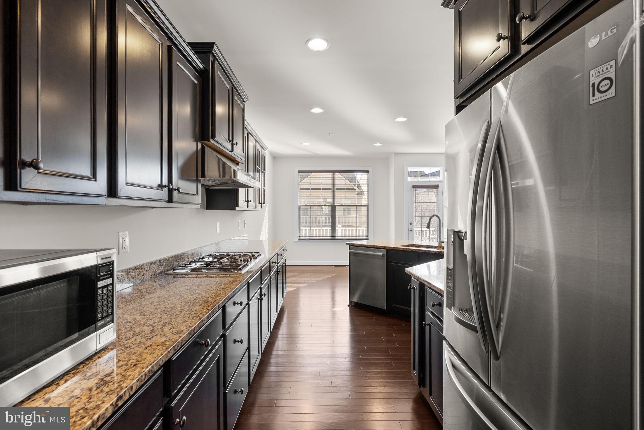 176 Autumn View Drive Gaithersburg, MD 20878 - Photo 14 of 45 a kitchen with stainless steel appliances granite countertop a refrigerator a stove and a wooden floors