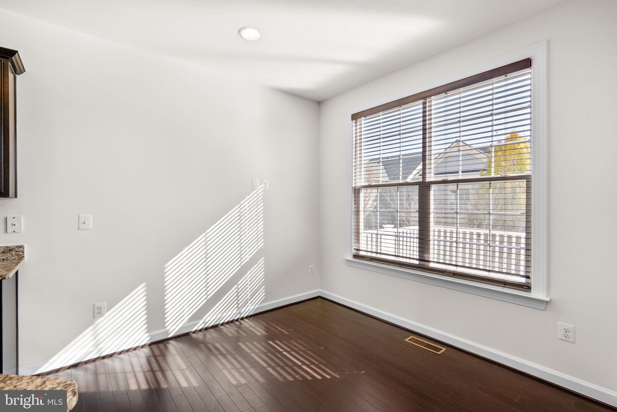 176 Autumn View Drive Gaithersburg, MD 20878 - Photo 19 of 45 a view of an empty room with wooden floor and a window