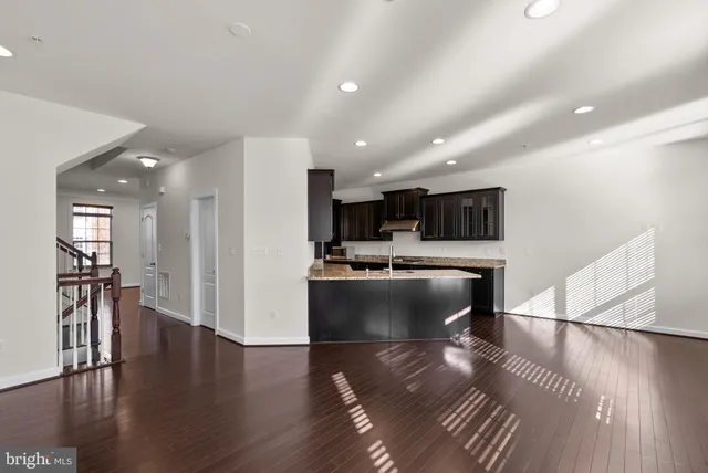 a view of kitchen with cabinets and wooden floor