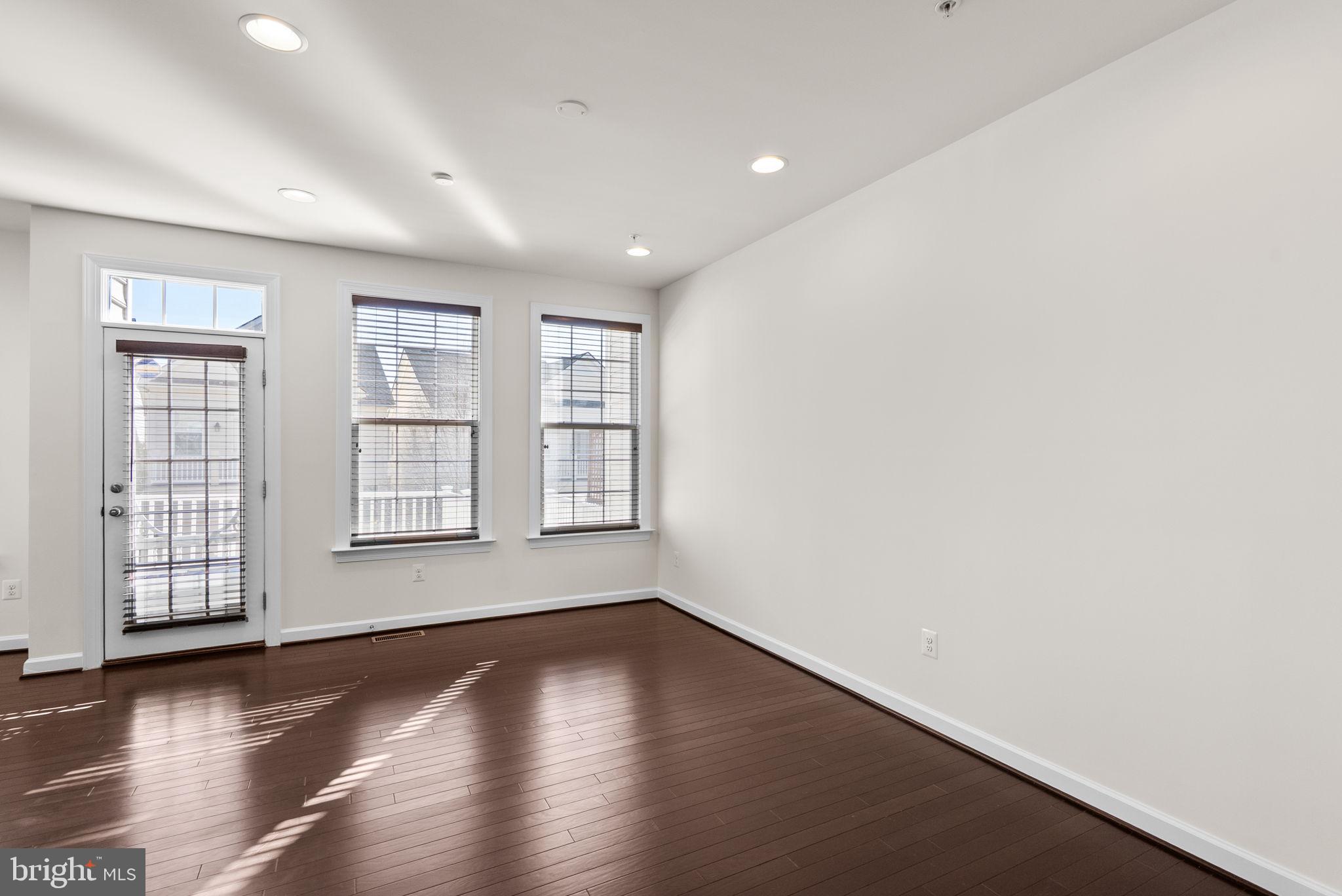 176 Autumn View Drive Gaithersburg, MD 20878 - Photo 24 of 45 an empty room with wooden floor and windows