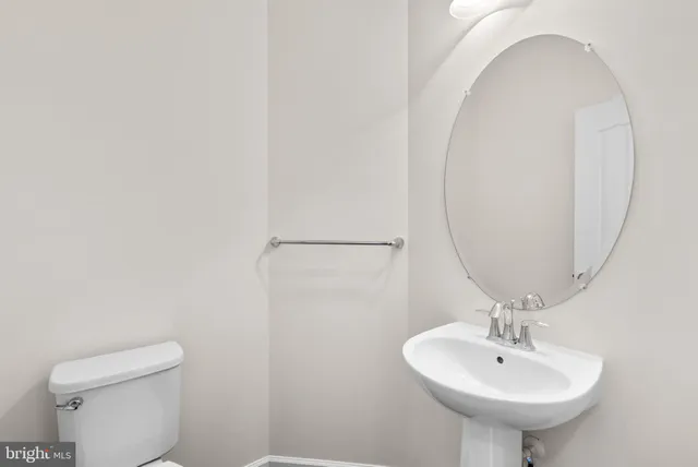 a bathroom with a sink a mirror and a toilet