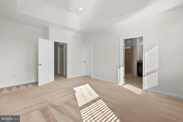 a view of a livingroom with wooden floor and bathroom