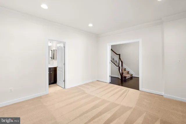 a view of a livingroom with wooden floor and a staircase